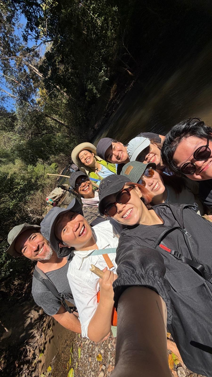 Corporate group photo by the river at Pai Seedlings Farm