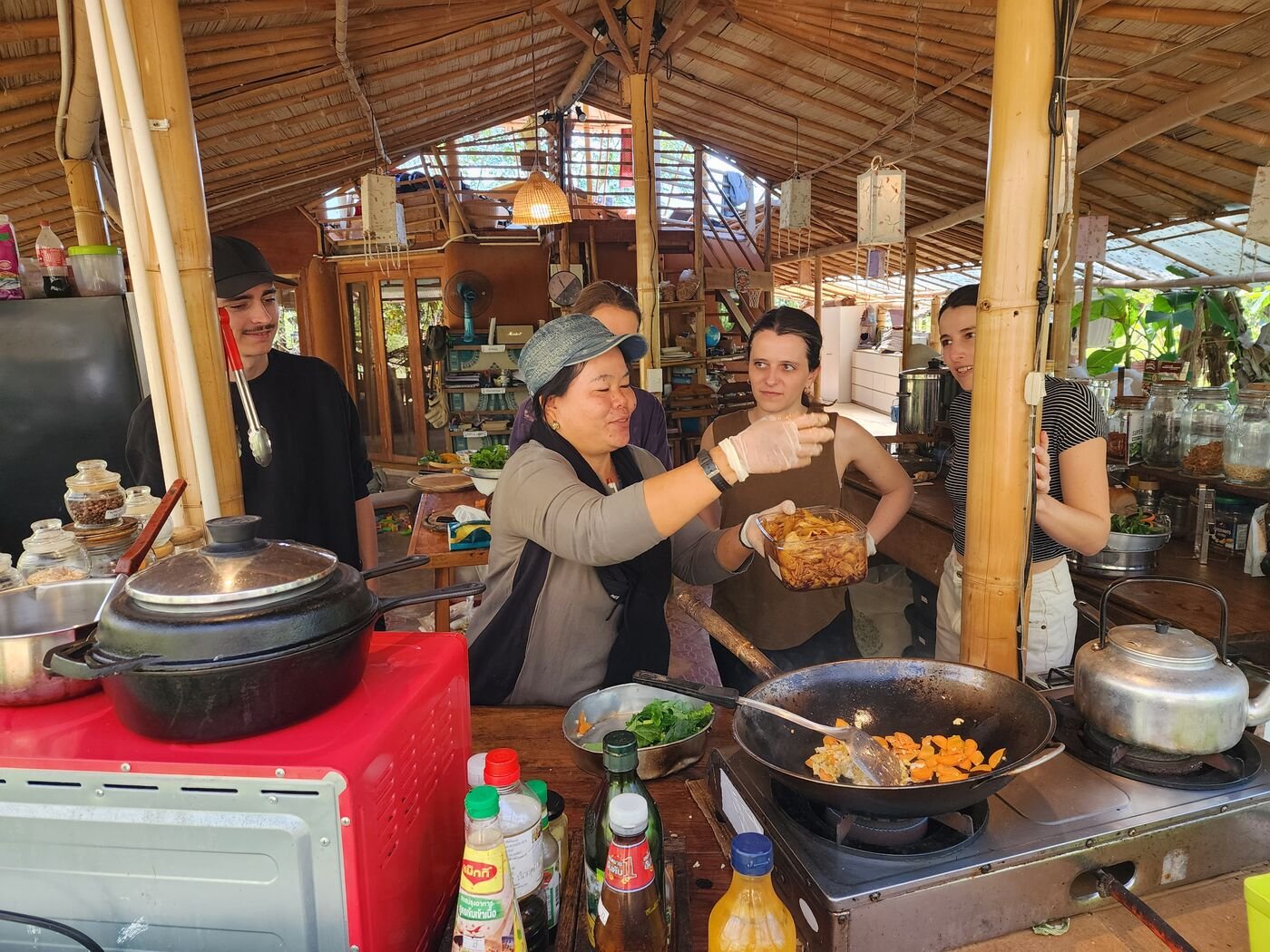 Cooking class in the farm's open-air kitchen at Pai Seedlings